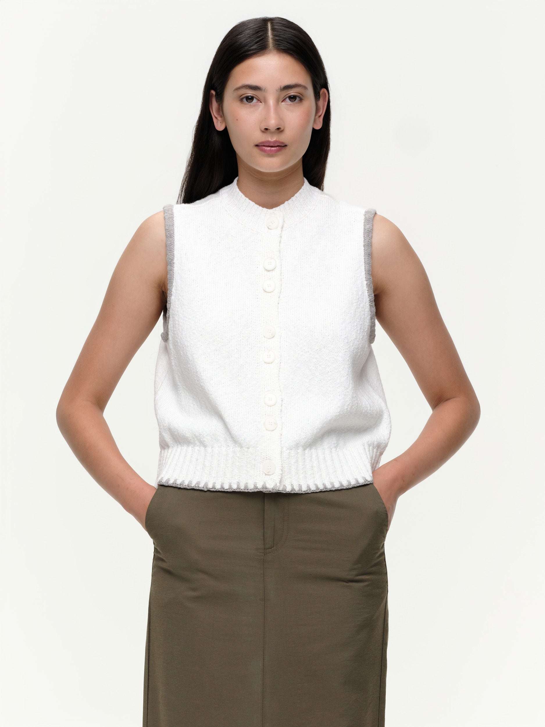 Mid-weight cotton knitted vest with a straight fit, featuring a textured twisted yarn, double-button front, and contrast blanket stitching.