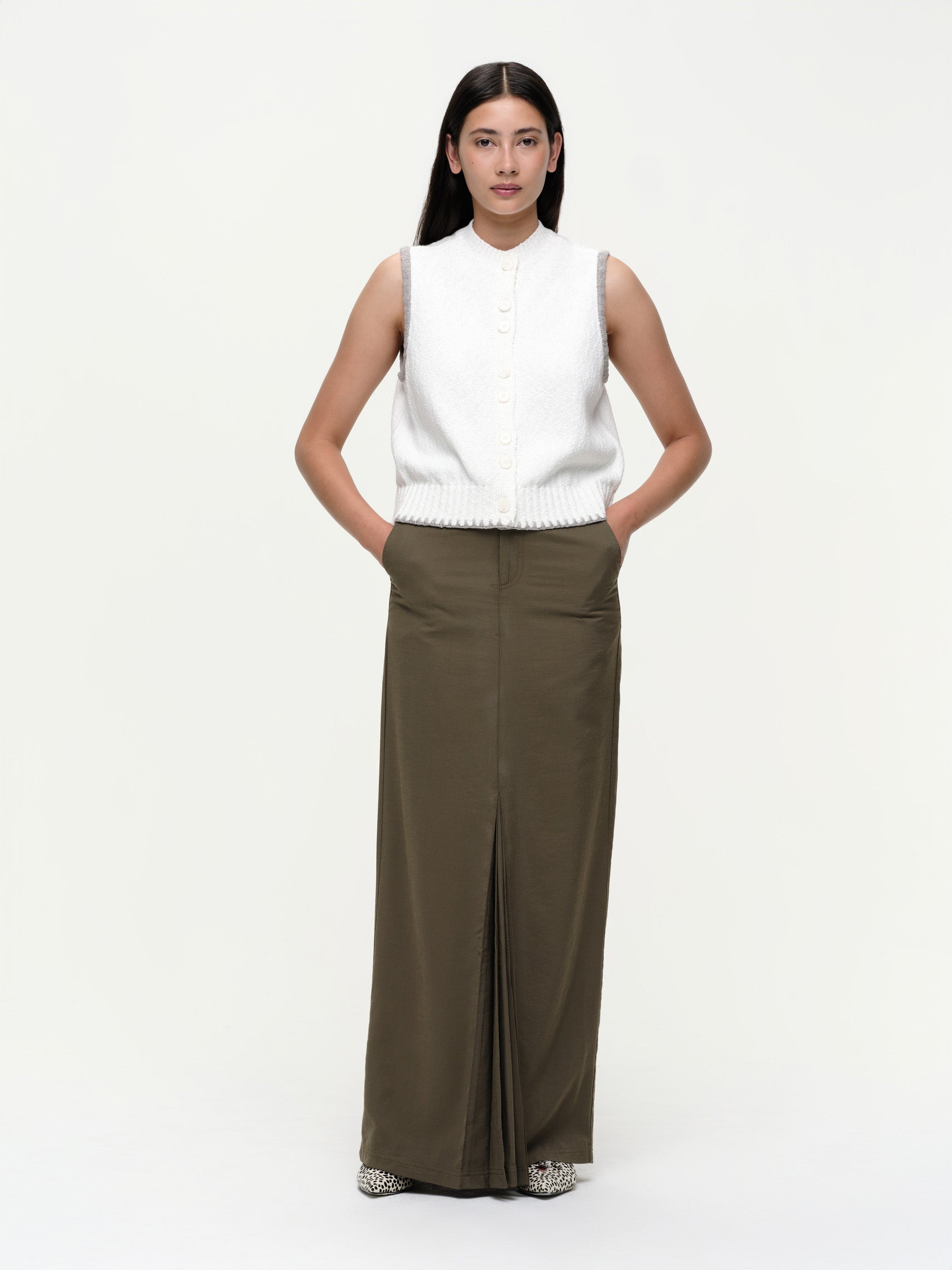 Mid-weight cotton knitted vest with a straight fit, featuring a textured twisted yarn, double-button front, and contrast blanket stitching.