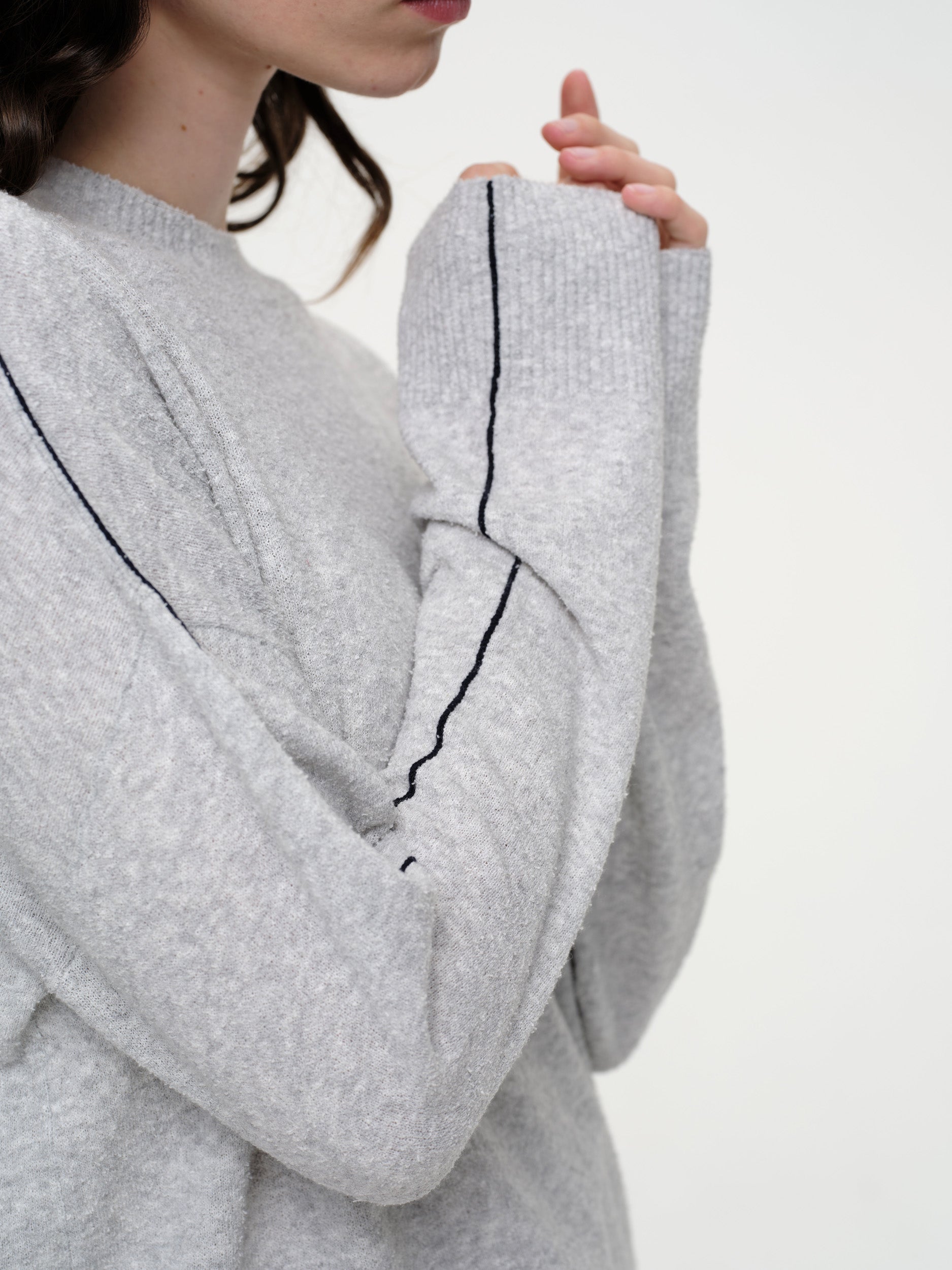 Lightweight bouclé knit summer sweater with a relaxed fit, featuring contrast stripe detailing at the back and sleeves and wide ribbed cuffs.