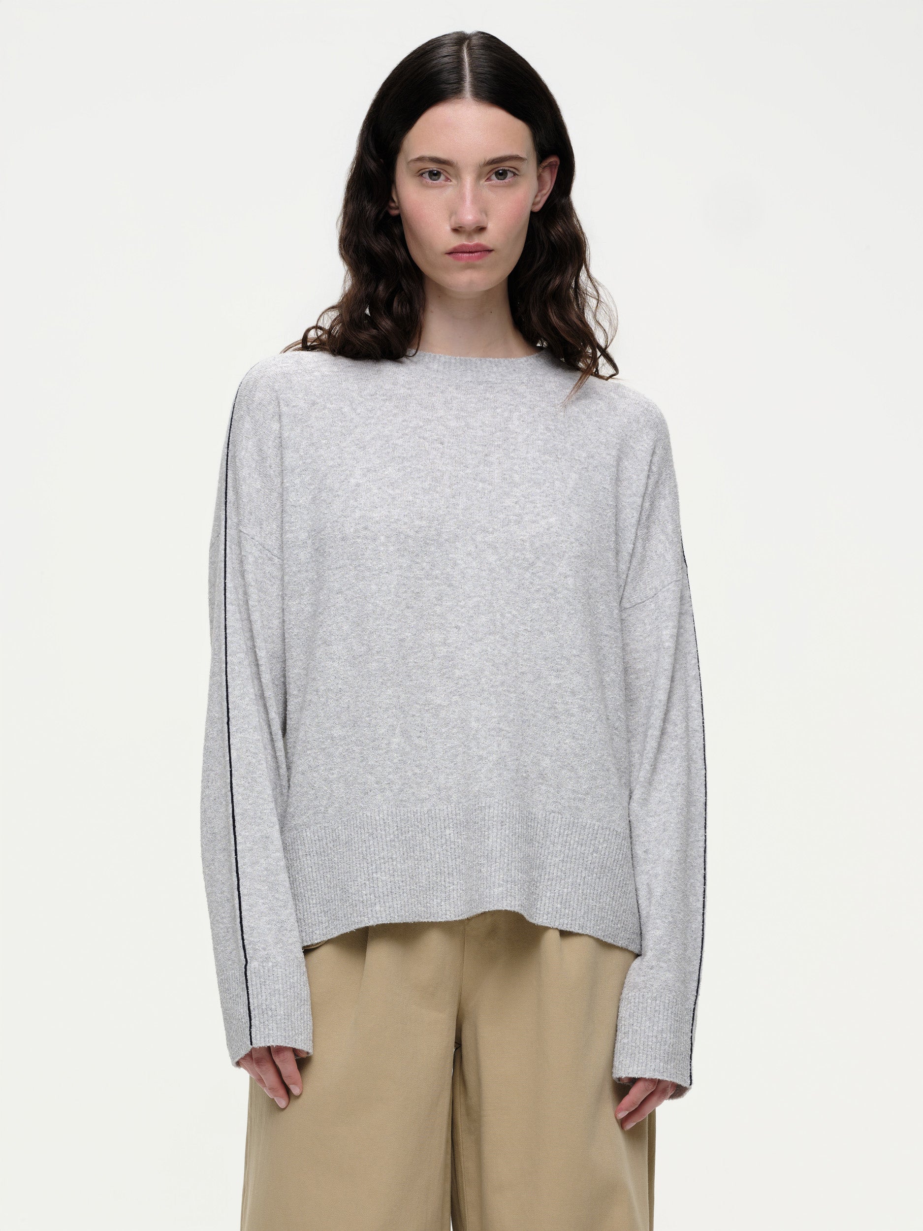 Lightweight bouclé knit summer sweater with a relaxed fit, featuring contrast stripe detailing at the back and sleeves and wide ribbed cuffs.