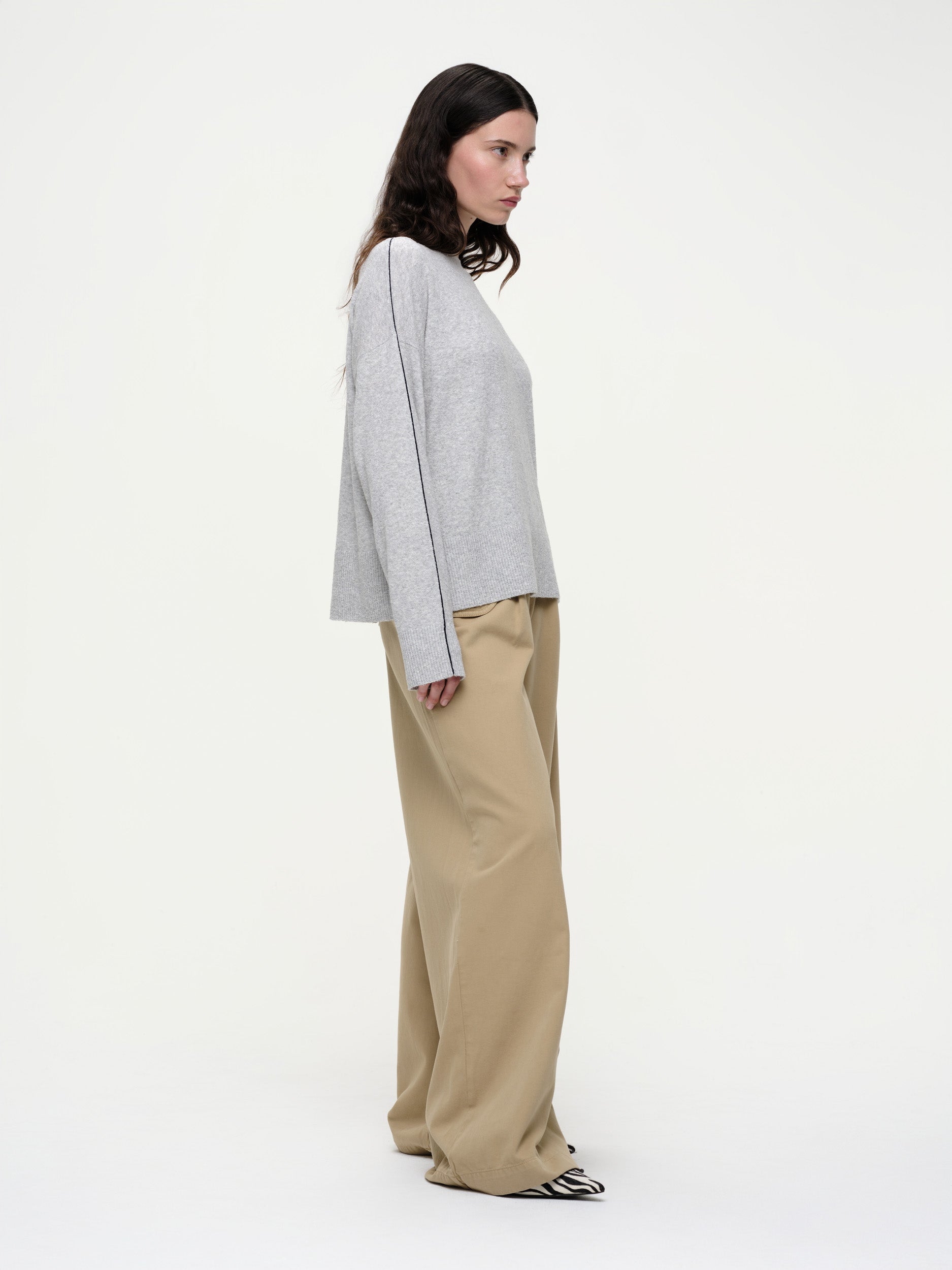 Lightweight bouclé knit summer sweater with a relaxed fit, featuring contrast stripe detailing at the back and sleeves and wide ribbed cuffs.