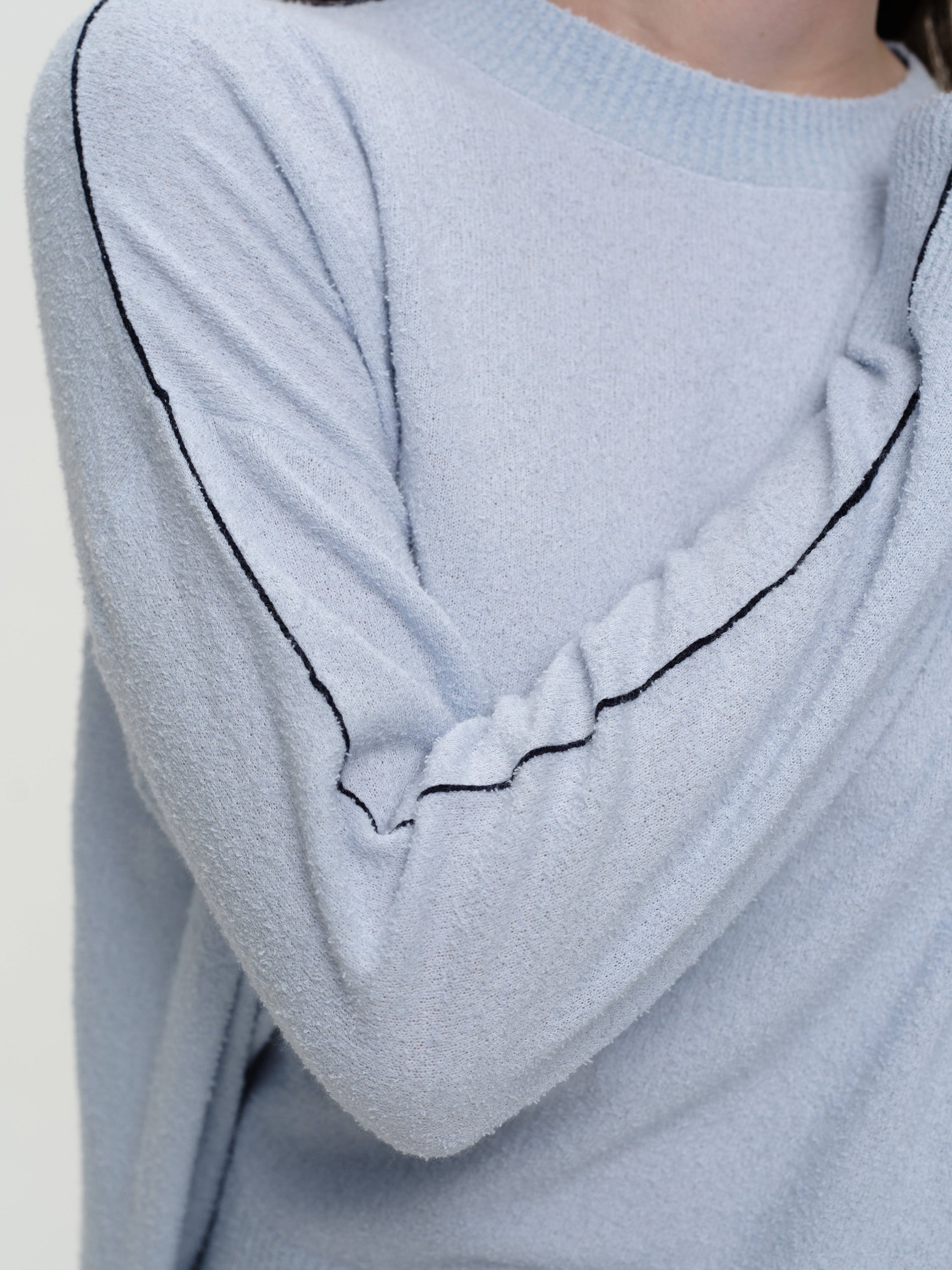 Lightweight bouclé knit summer sweater with a relaxed fit, featuring contrast stripe detailing at the back and sleeves and wide ribbed cuffs.